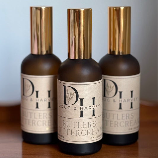 Three bottles of Butlers Buttercream on a wooden surface with a light blue background