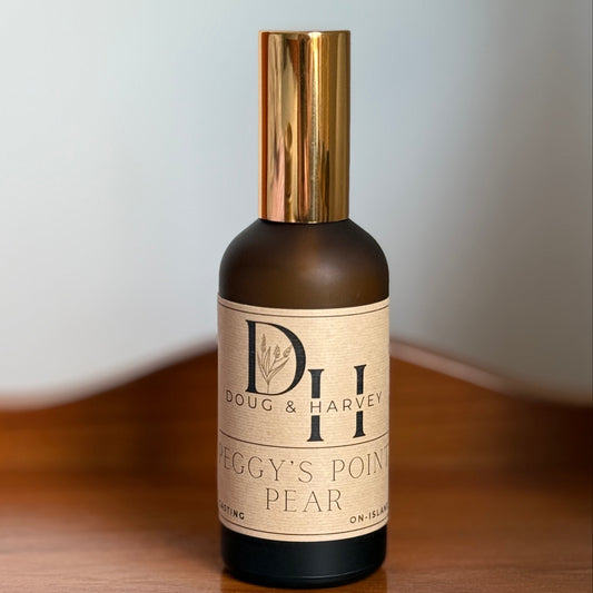 Bottle of Doug & Harvey Peggy's Point Pear Room Spray on a wooden surface with a light gray background