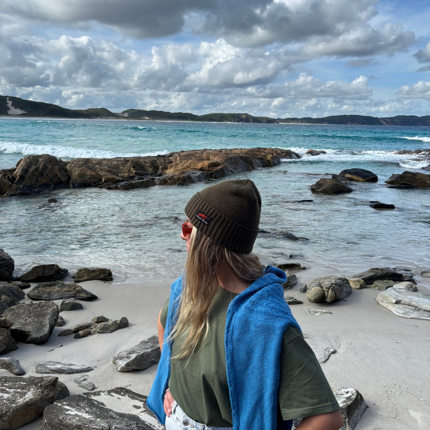 Tasmanian beach lifestyle wearing olive beanie
