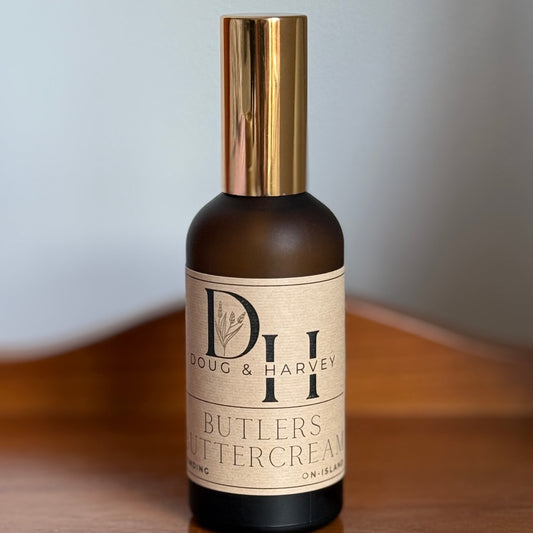 Bottle of Butlers Buttercream room and linen spray on a wooden surface with a neutral background