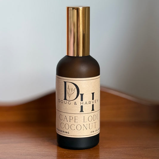Bottle of Doug & Harvey Cape Lodi Coconut on a wooden surface with a neutral background