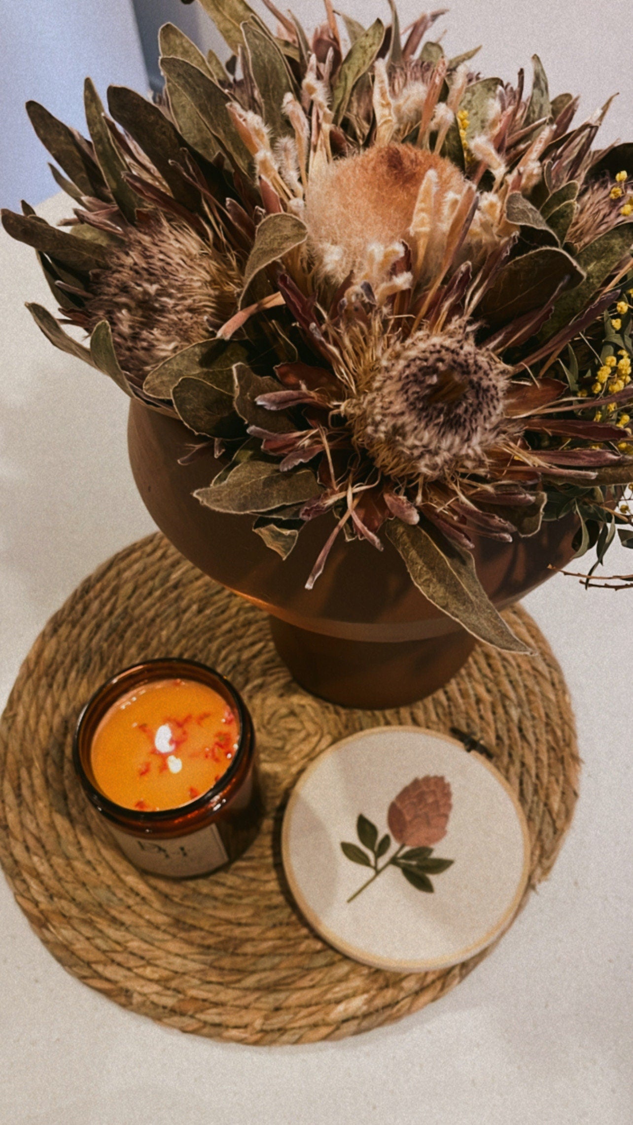 Large handcrafted Cape Lodi Coconut Candle Cocosoy wax candle in amber glass jar with gold lid, adorned with native dried flowers, made in Tasmania