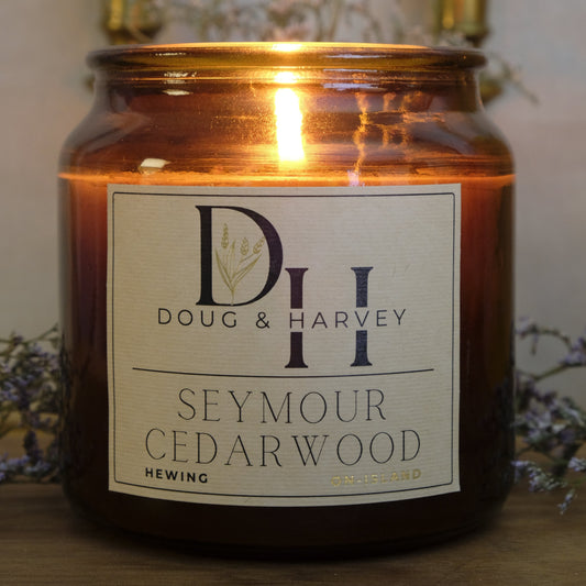 Seymour Cedarwood candle with a visible label on a wooden surface