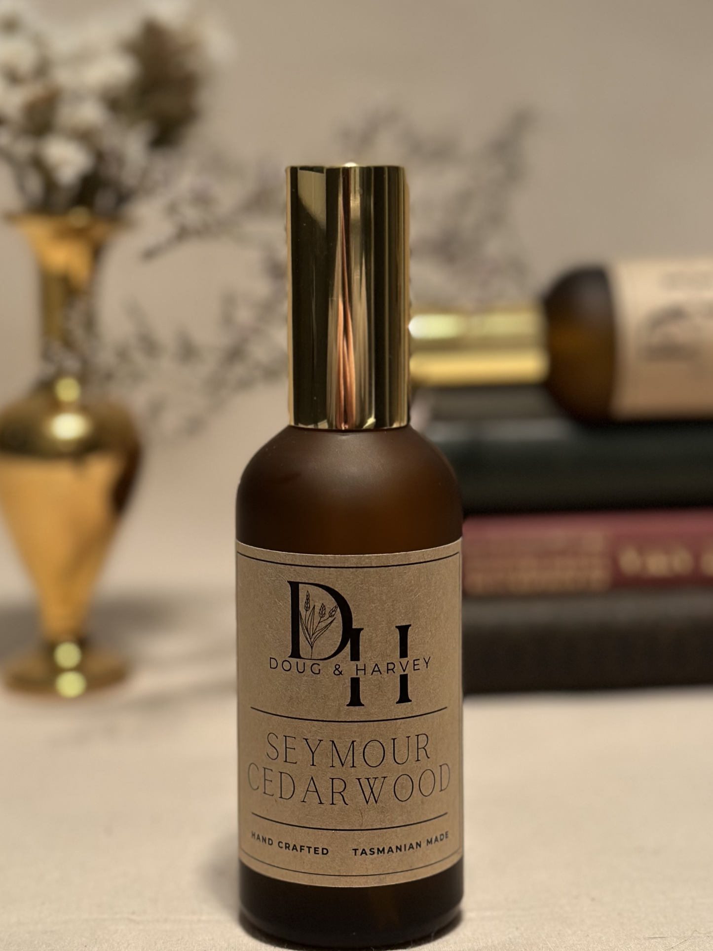 A brown glass perfume bottle with a gold atomizer, showcasing the distinctive Doug & Harvey Seymour Cedarwood fragrance. Handcrafted in Tasmania, this product embodies the brand's commitment to quality and natural ingredients.