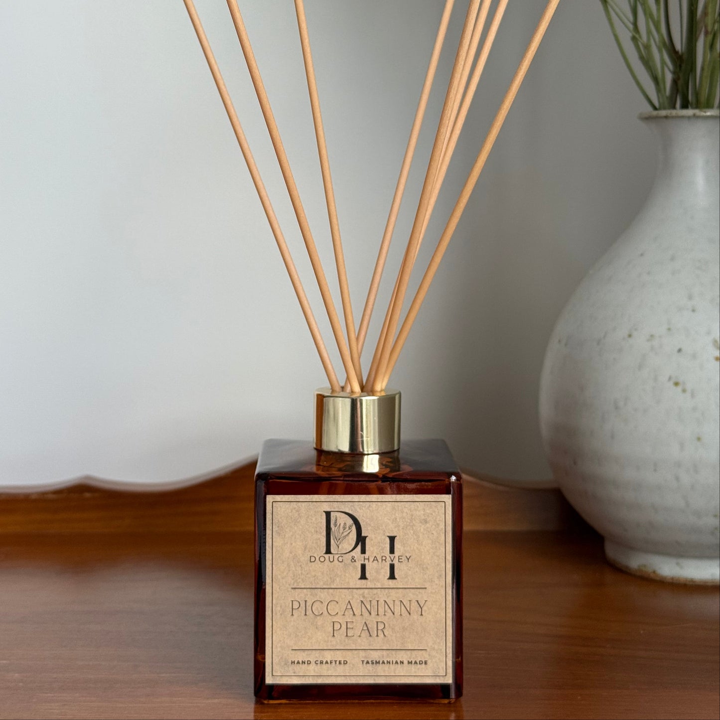 Diffuser with wooden sticks on a white surface