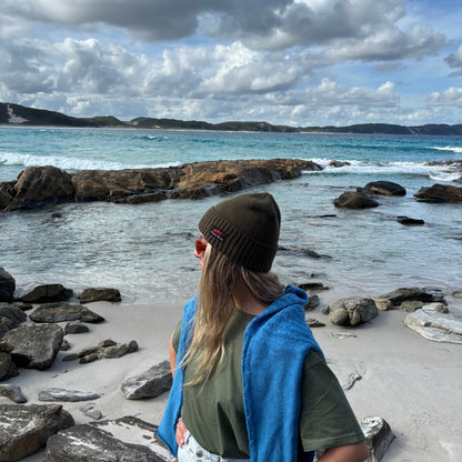 Tasmanian beach lifestyle wearing olive beanie
