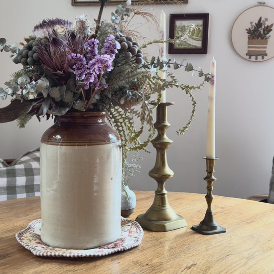 inserting rattan reeds into pear natural reed diffuser with country setting