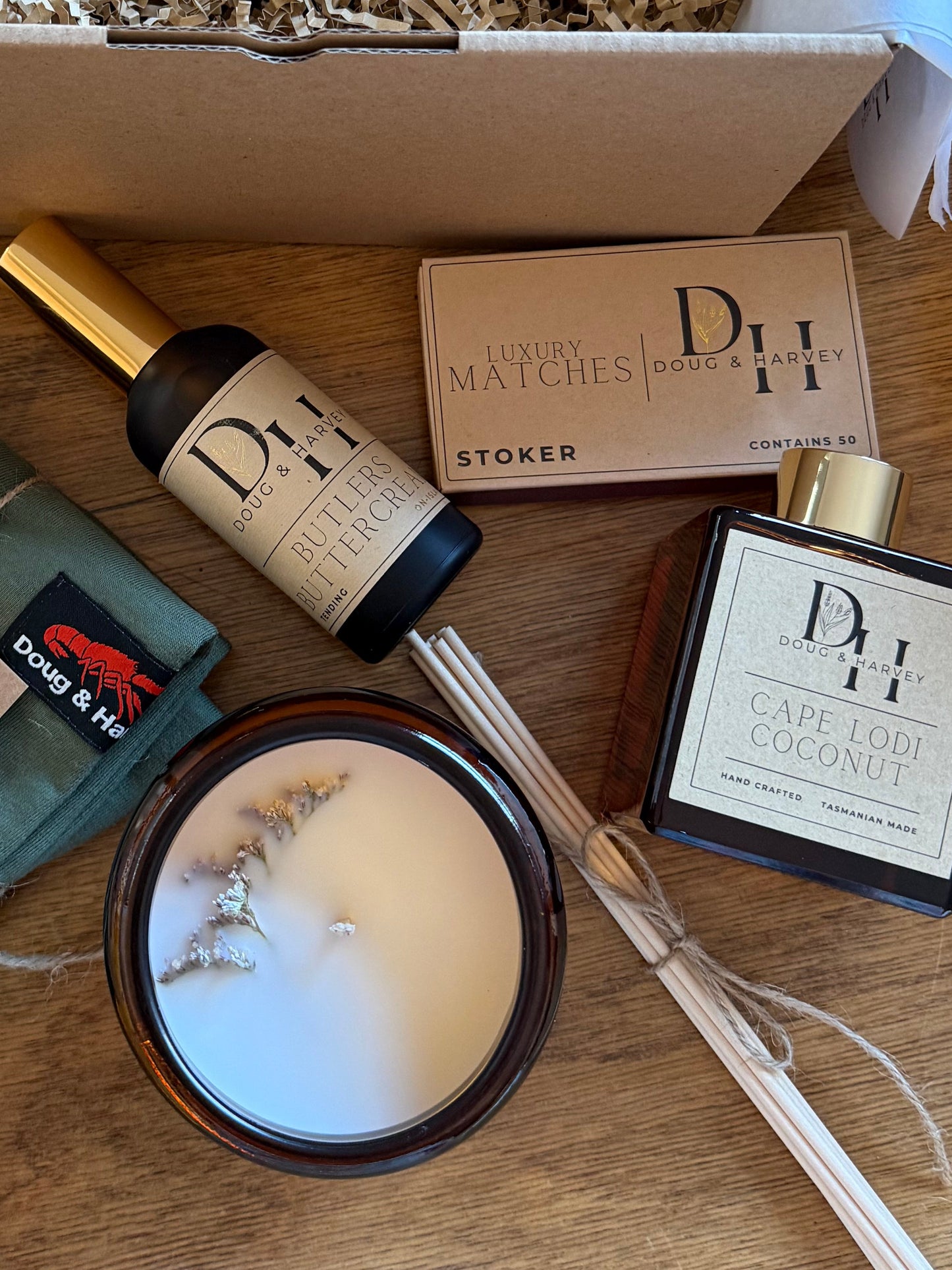 Doug & Harvey luxury matches Stoker with raised text and gold detail styled with candle and home fragrance products