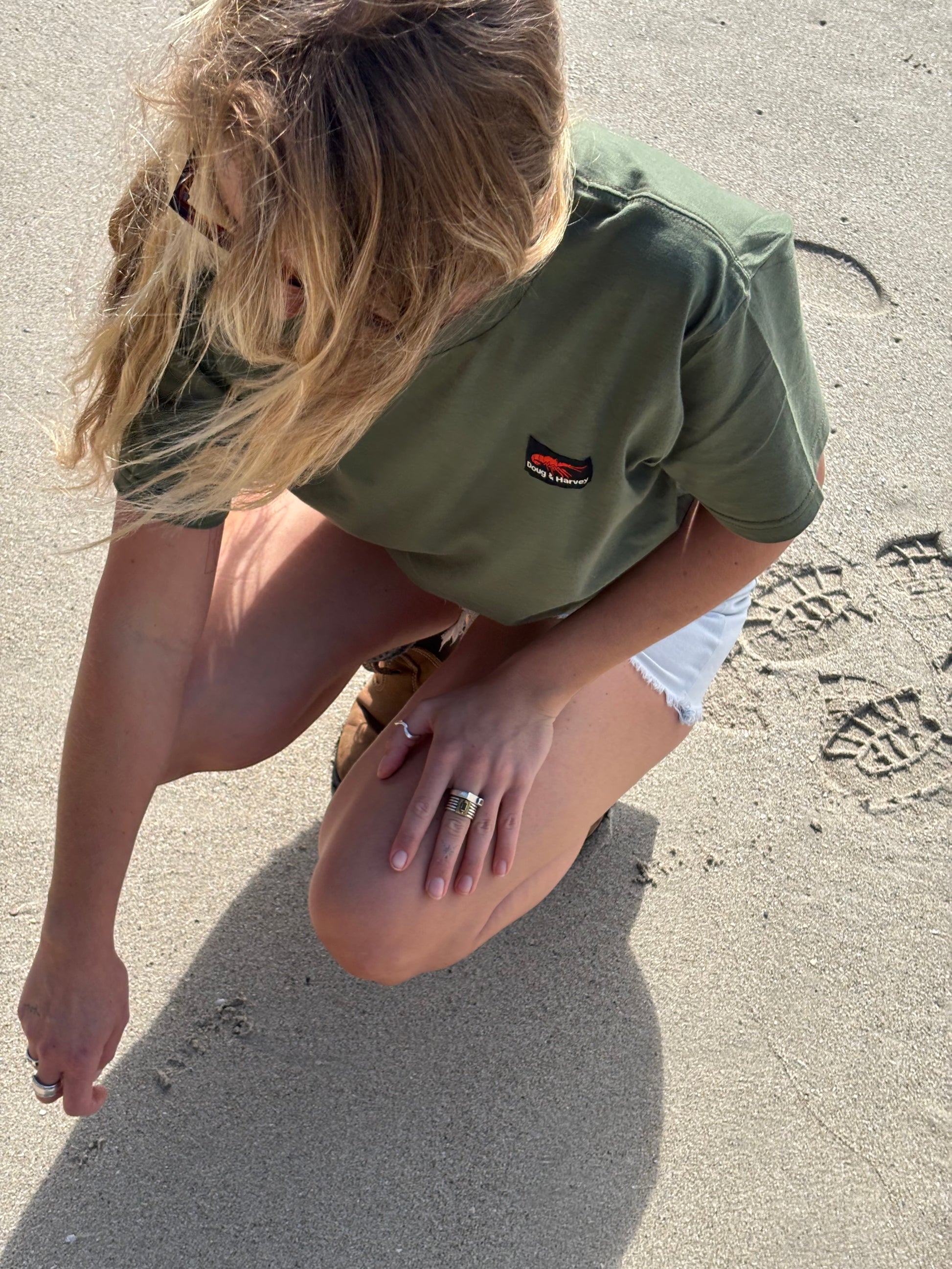 olive Trap Reef tee worn on beach in Bicheno Tasmania coastal lifestyle clothing